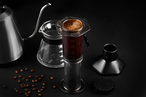 AeroPress on black background .The AeroPress is a device for brewing coffee. Coffee brewing